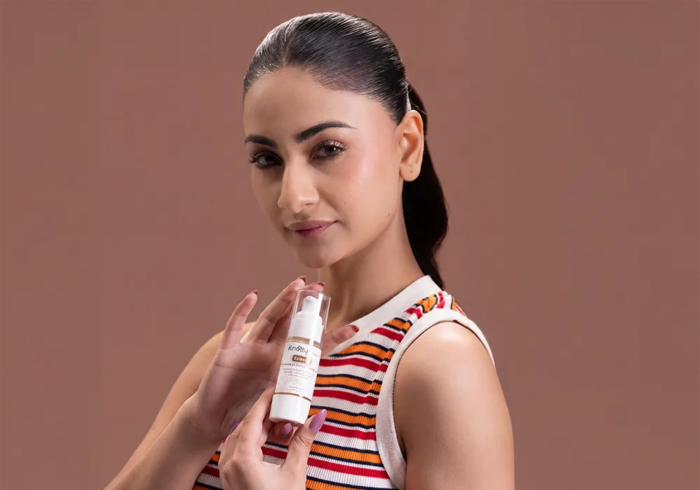 Woman holding a skin lightening serum designed to reduce dark spots, improve uneven skin tone, and enhance overall skin clarity.